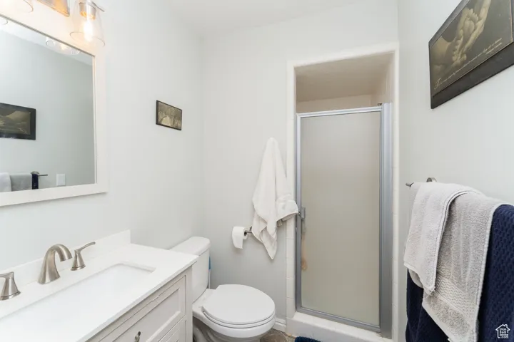 Full bathroom featuring vanity and a shower stall