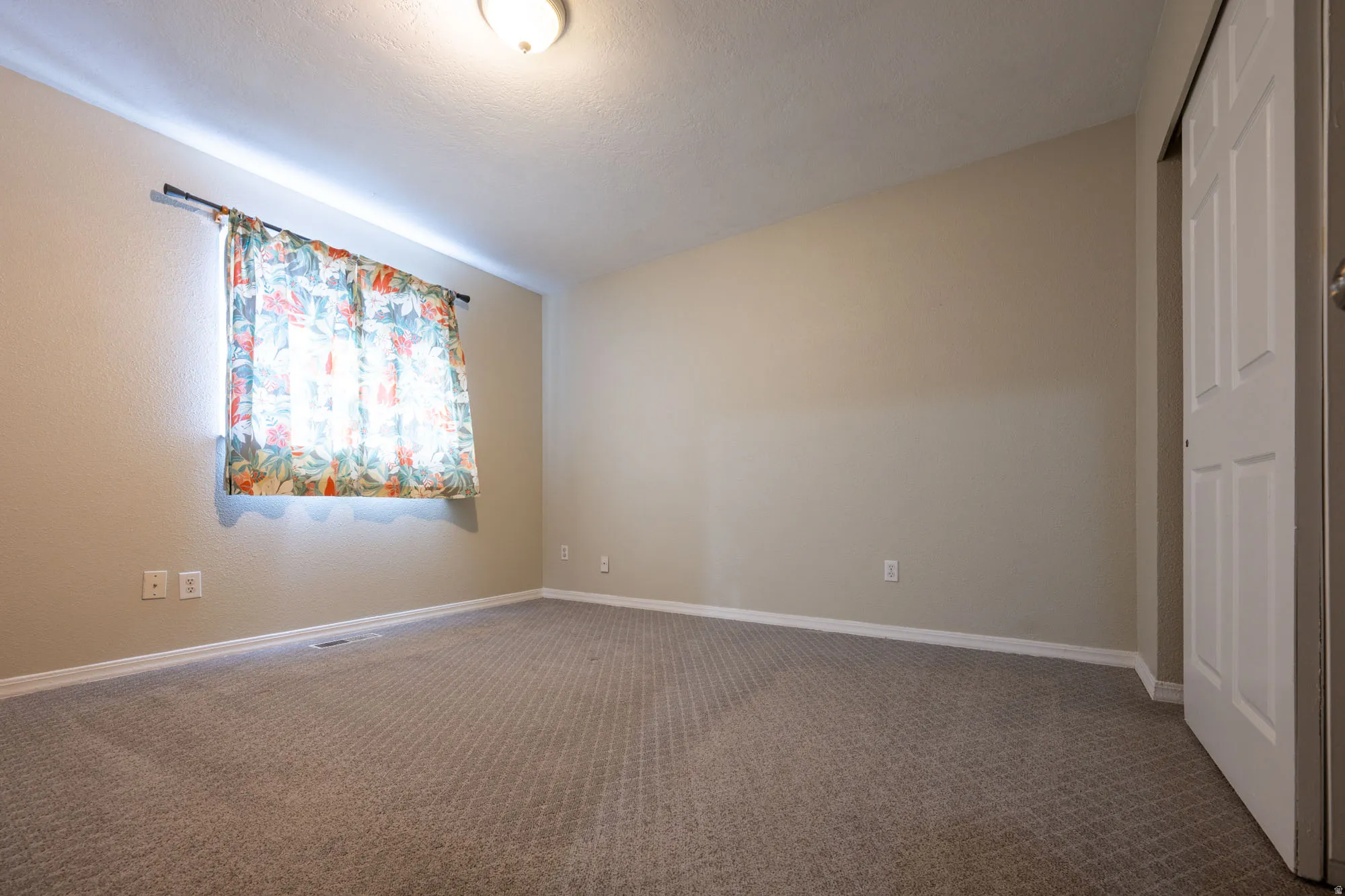 Main bedroom featuring carpet floors and a closet