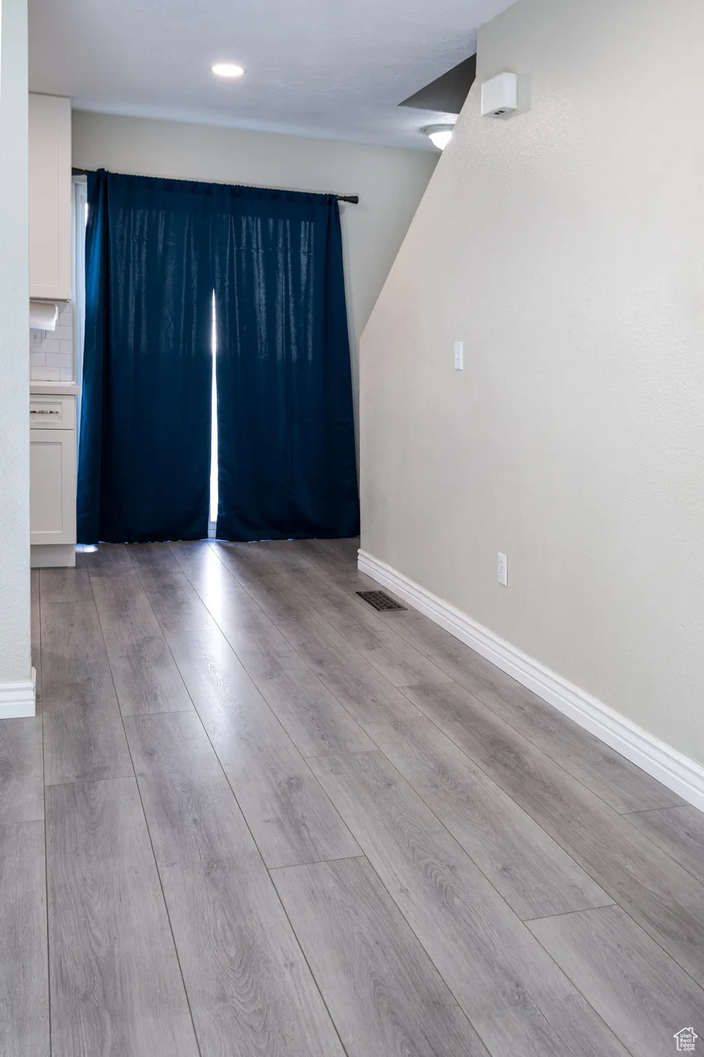 Dining room featuring light wood-style flooring and baseboards