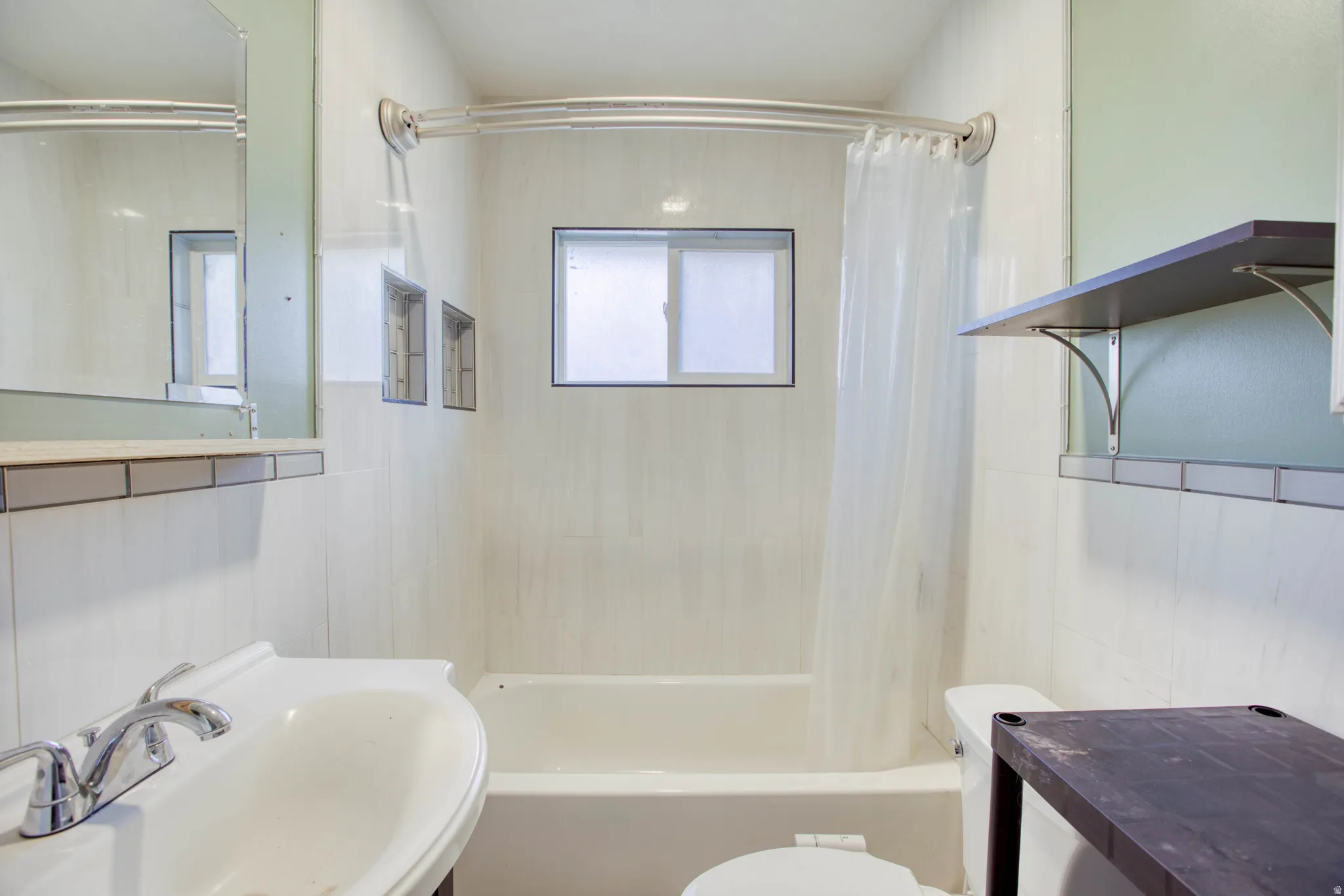 Full bath featuring shower / bath combo with shower curtain and vanity
