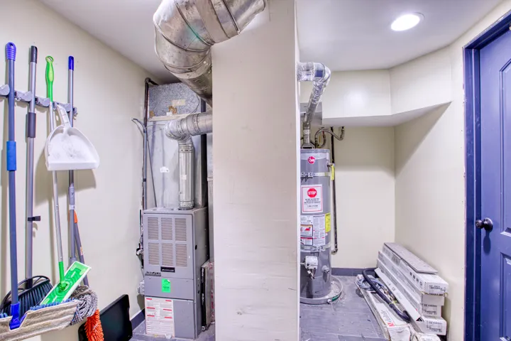 Utility room with heating unit and secured water heater