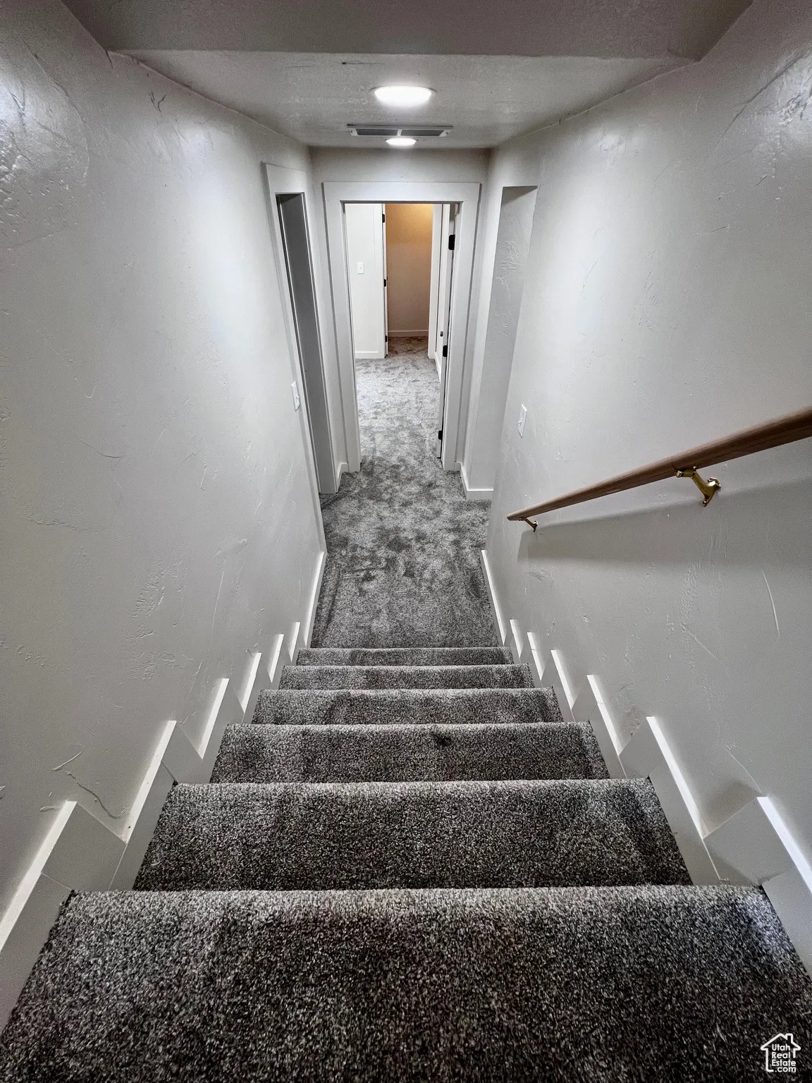 Staircase featuring carpet flooring and baseboards