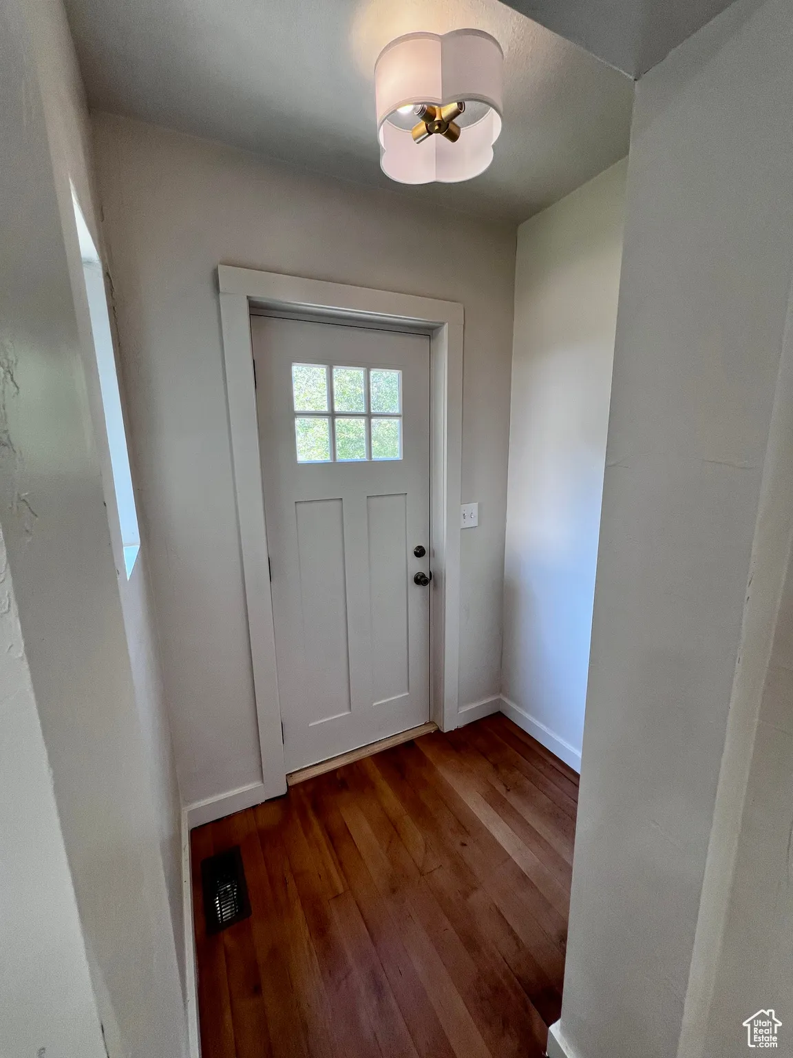 Entryway with wood finished floors and baseboards