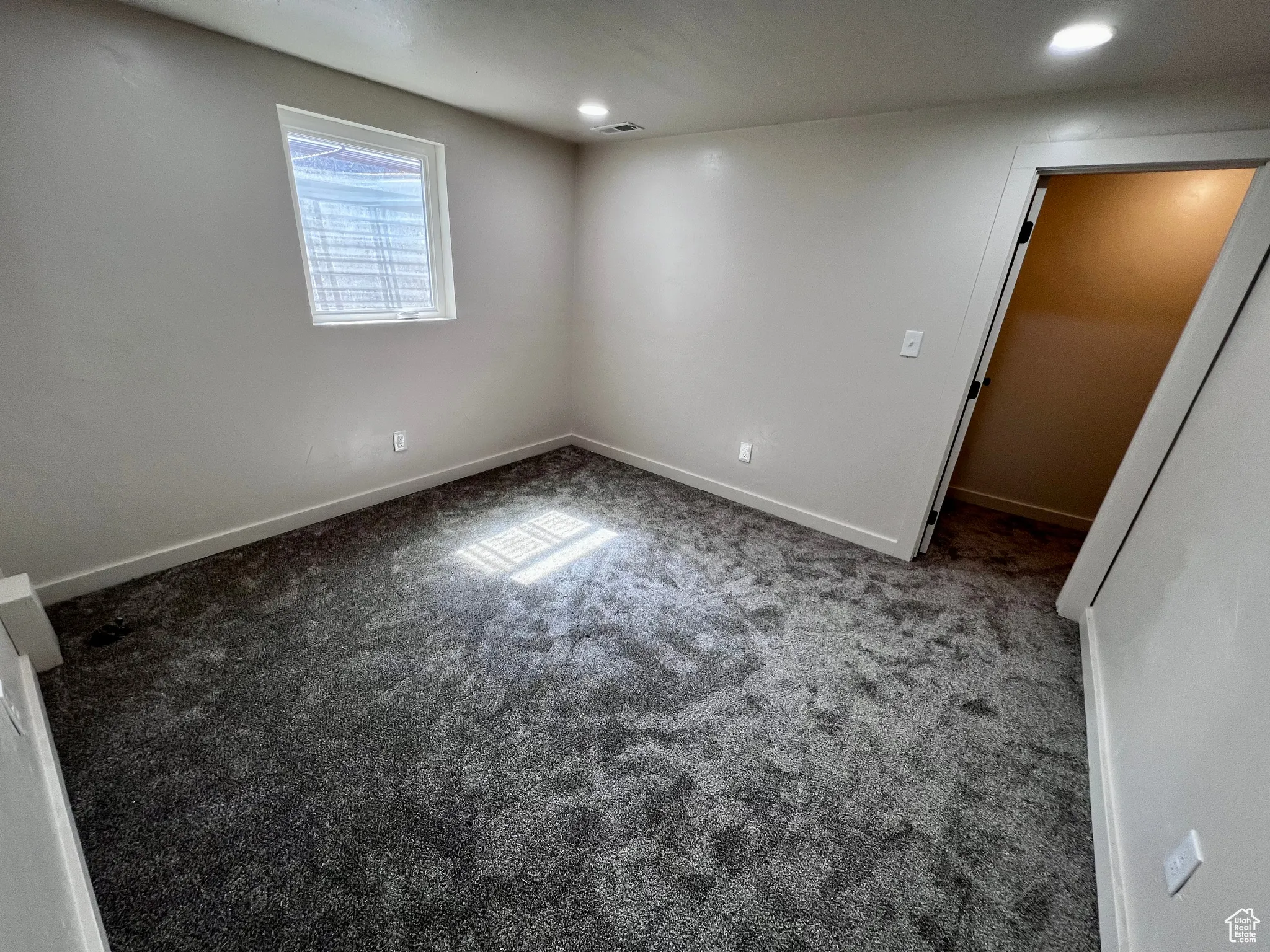 Below grade area with carpet floors and recessed lighting