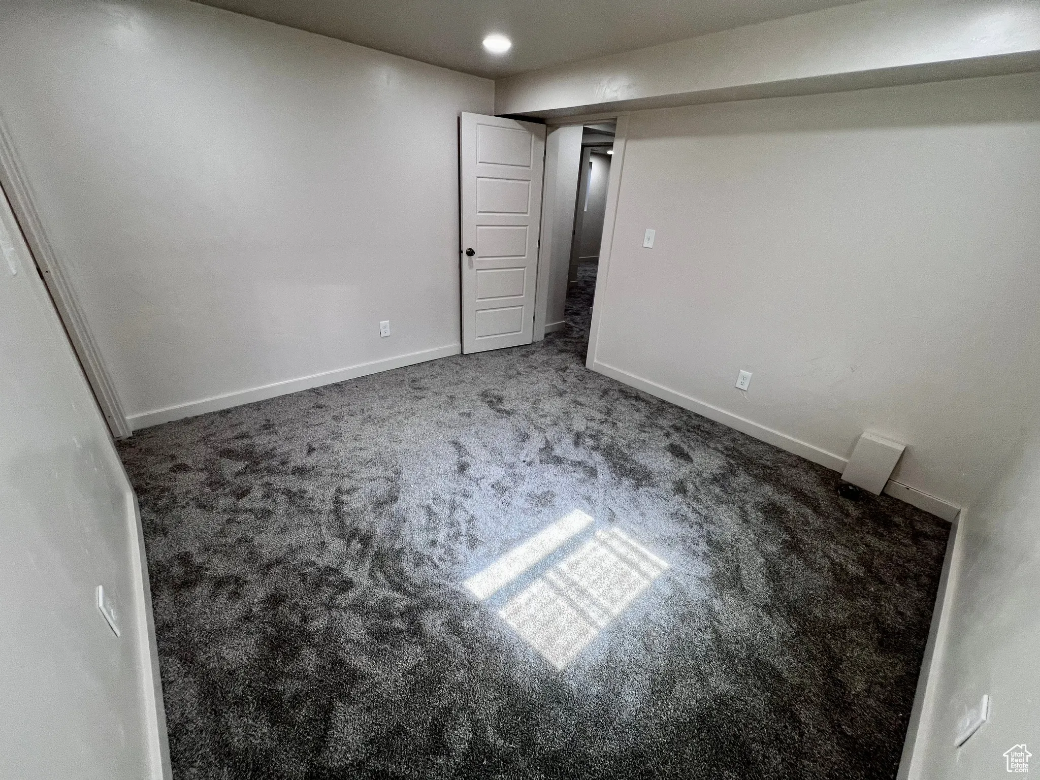 Below grade area featuring carpet flooring and baseboards