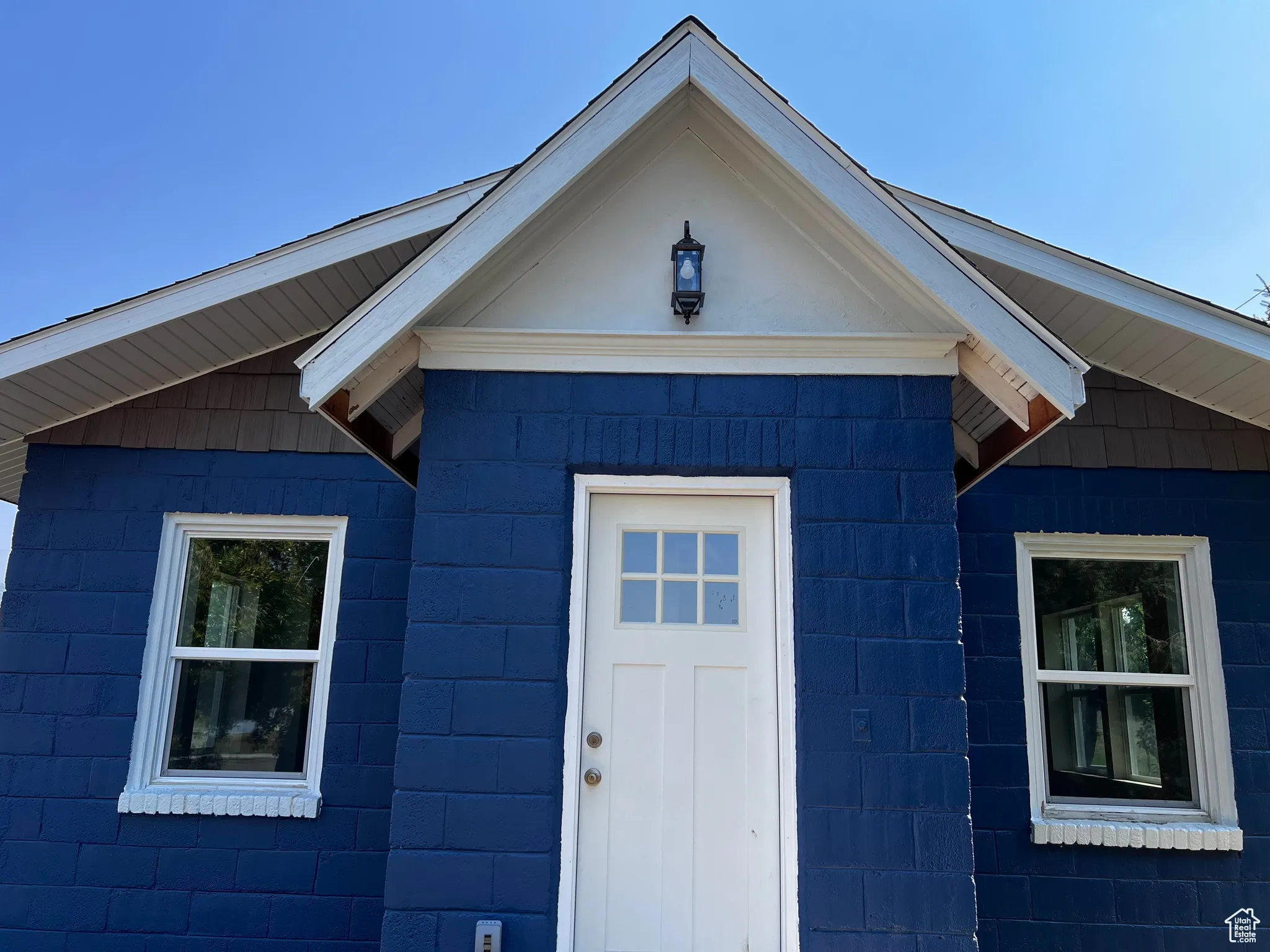 View of exterior entry featuring concrete block siding