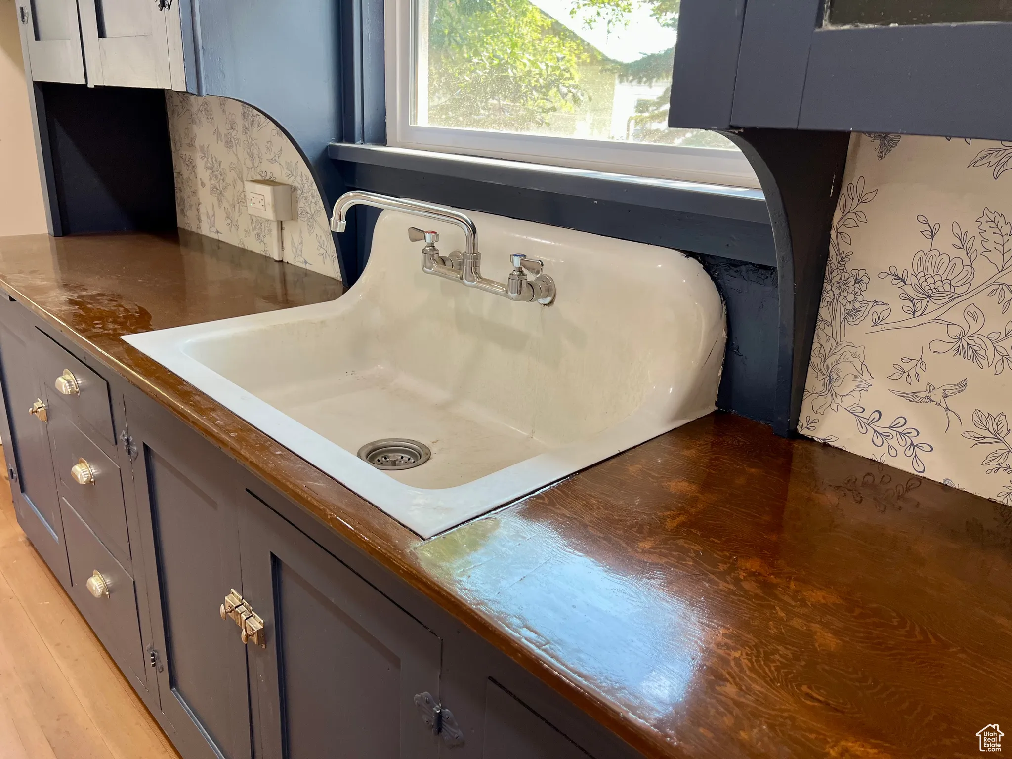Kitchen view of gray cabinets and dark countertops