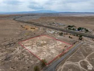 Overview of rural landscape featuring property parcel outlined and a mountainous background