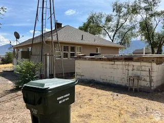 Back of property with a shingled roof
