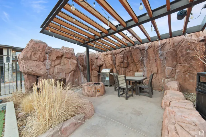 View of patio with a pergola, outdoor dining space, and a grill