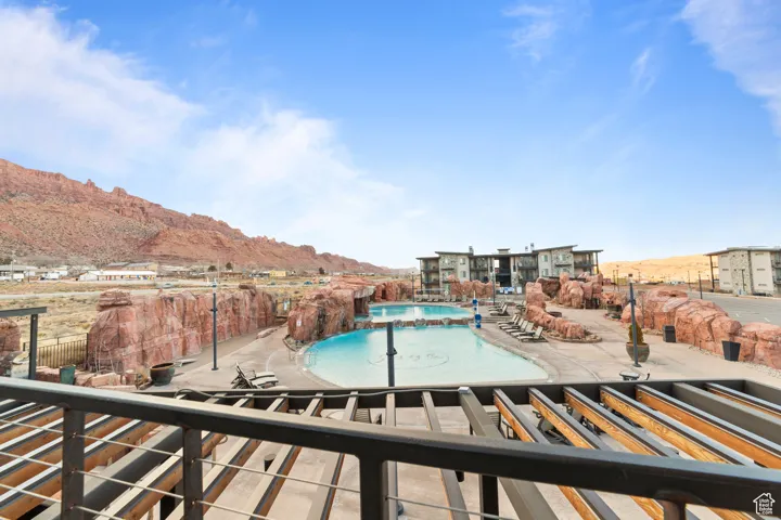 Community pool with a mountain view and a patio area