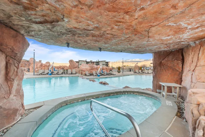 Community pool with a community hot tub and a patio area