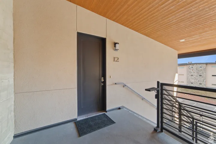 Property entrance with stucco siding