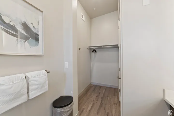 Bathroom with light wood-type flooring and baseboards