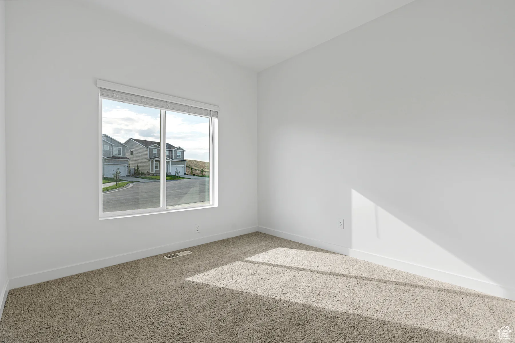 Empty room featuring carpet floors and baseboards