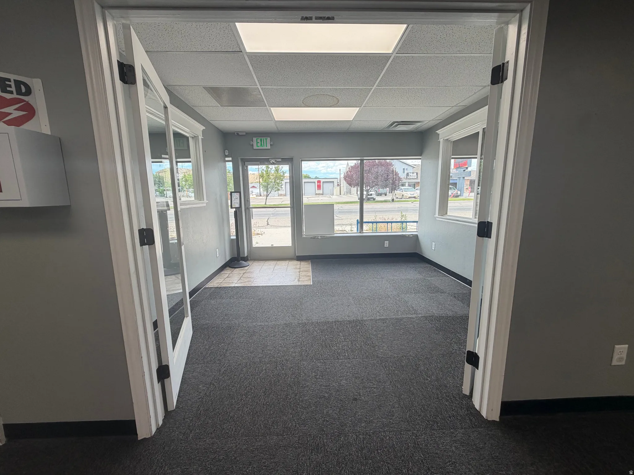 Spacious interior room with dark gray carpeting