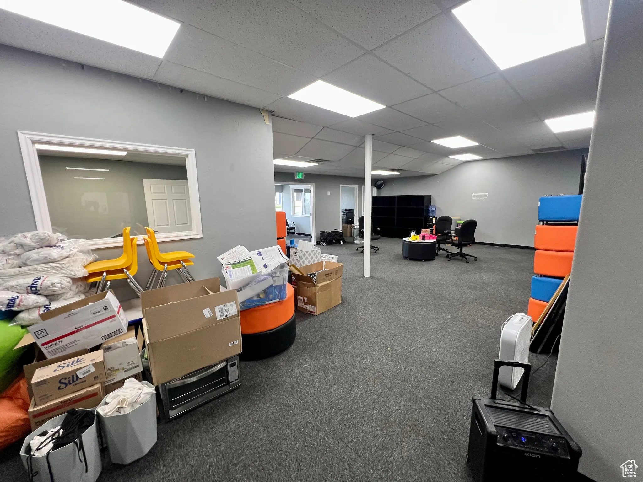 Below grade area with a drop ceiling and carpet floors