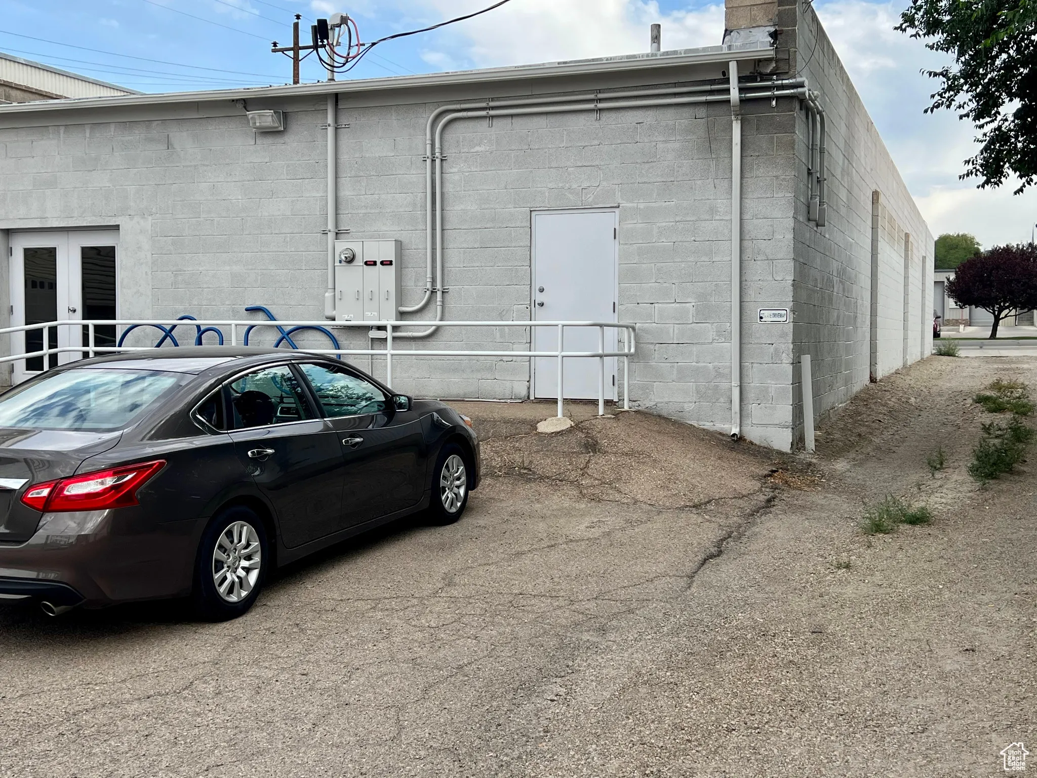 View of property exterior with concrete block siding