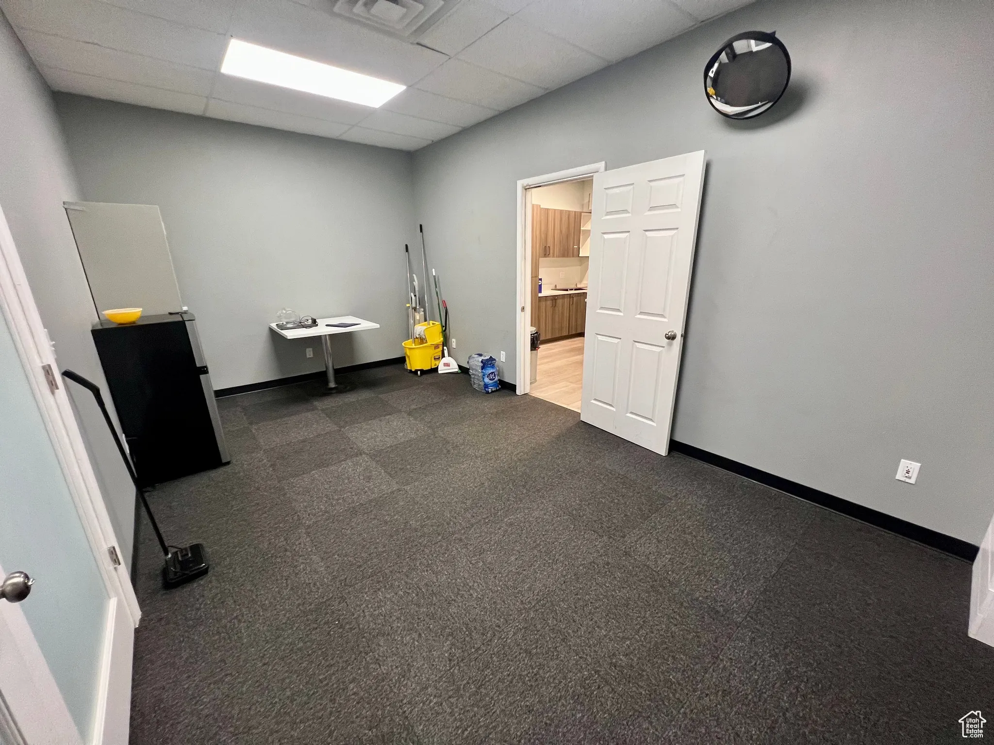 Miscellaneous room featuring a paneled ceiling and baseboards