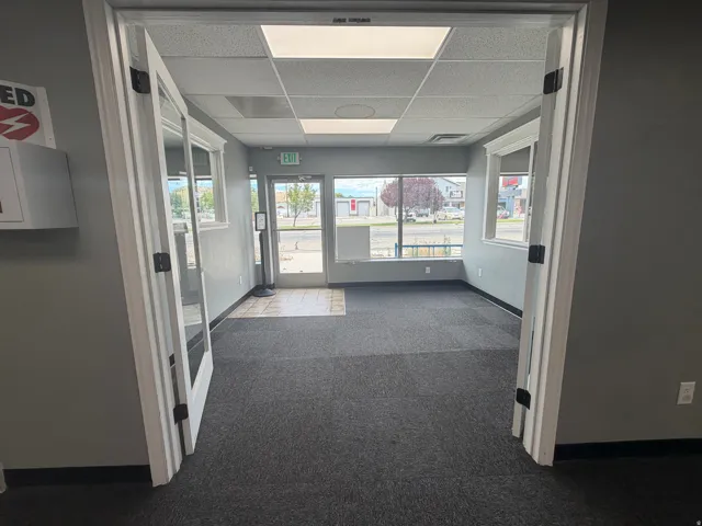 Spacious interior room with dark gray carpeting