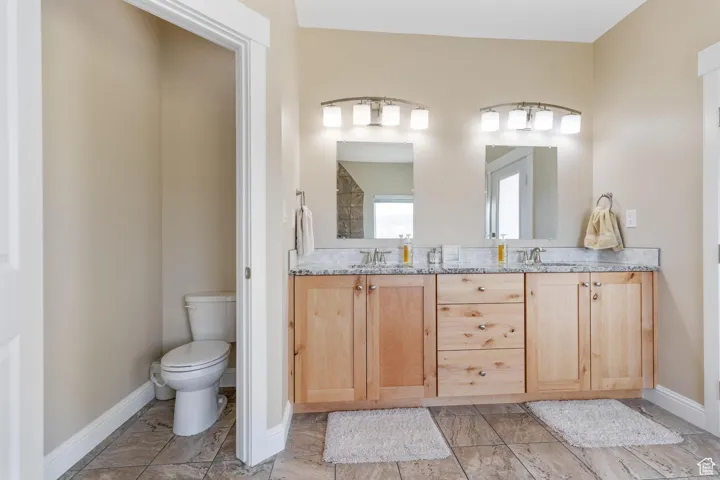 Main bathroom with double vanity and toilet room.