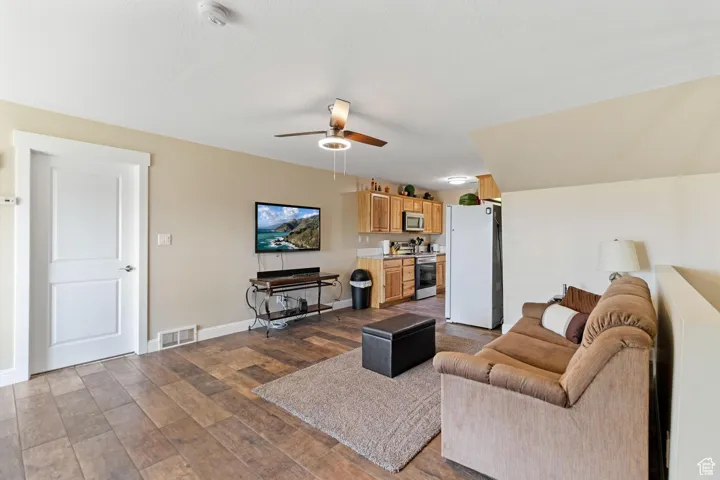 ADU: Living room with dark wood-type flooring and a ceiling fan