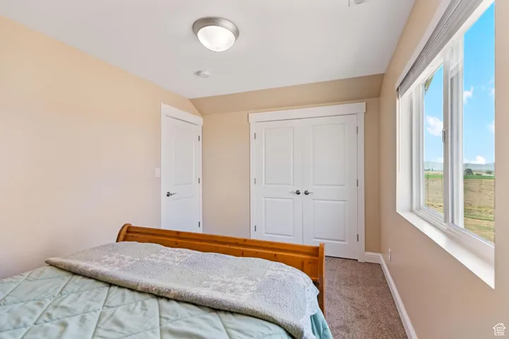 ADU: Carpeted bedroom with baseboards and a closet