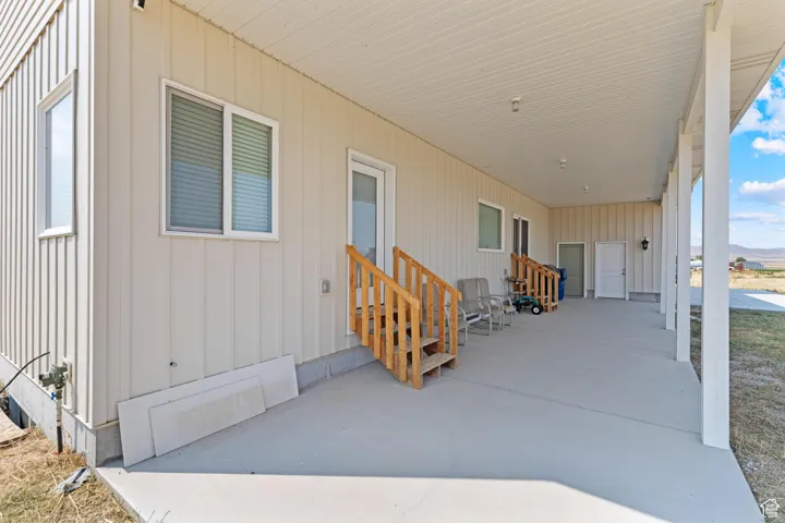 Porch with entry steps and an attached carport