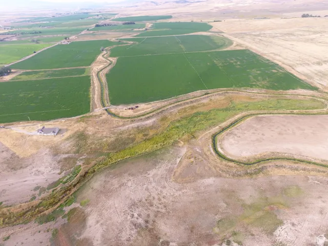 Aerial overview of property's location featuring rural landscape and extensive farmland