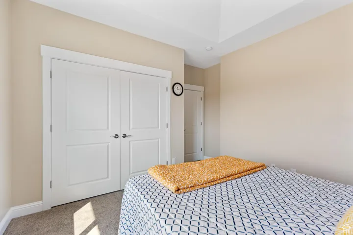 Second bedroom featuring carpet flooring and a closet