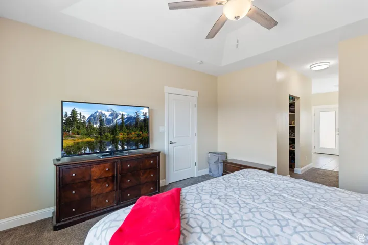 Main bedroom featuring baseboards and ceiling fan
