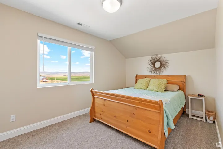 ADU: Bedroom featuring light colored carpet, lofted ceiling, and a mountain view