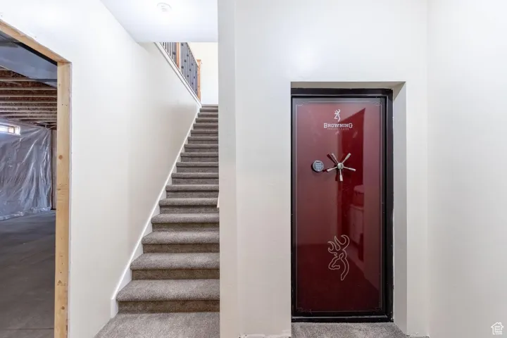 Stairway featuring carpet flooring and safe room.