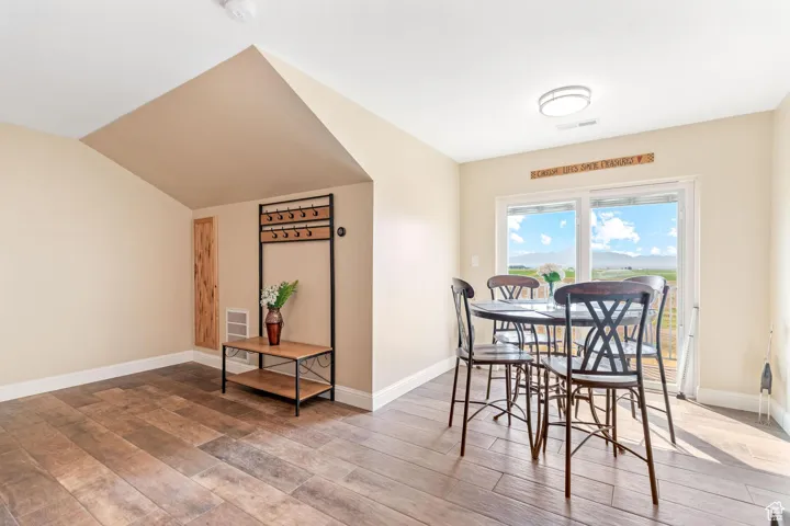 ADU: Dining room featuring light wood finished floors and lofted ceiling
