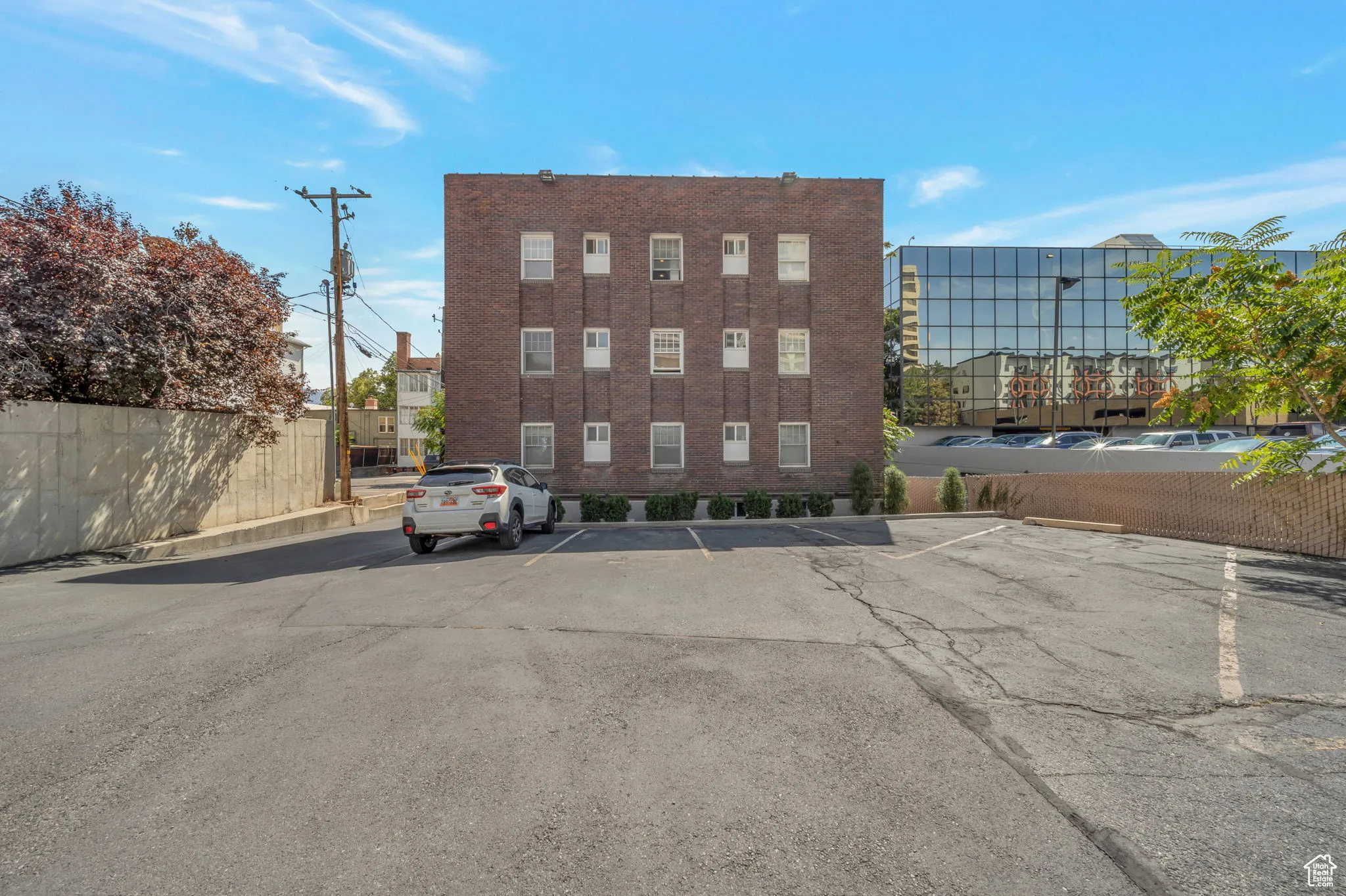 View of apartment building / complex featuring uncovered parking