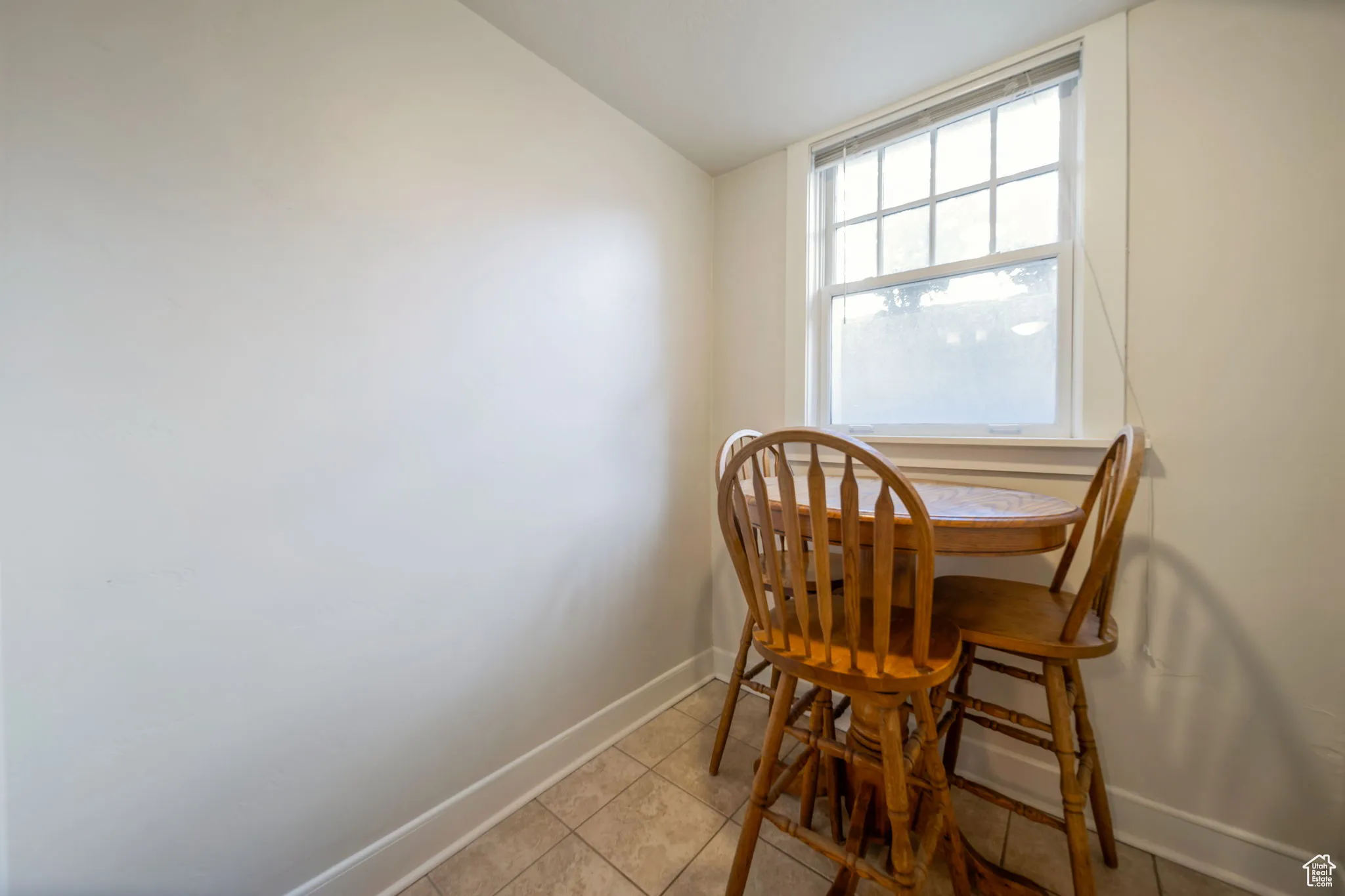 Dining area with light tile patterned floors and lofted ceiling