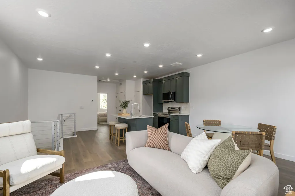 Bright, open living room with large windows and seamless flow—perfect for city living and entertaining. *model home