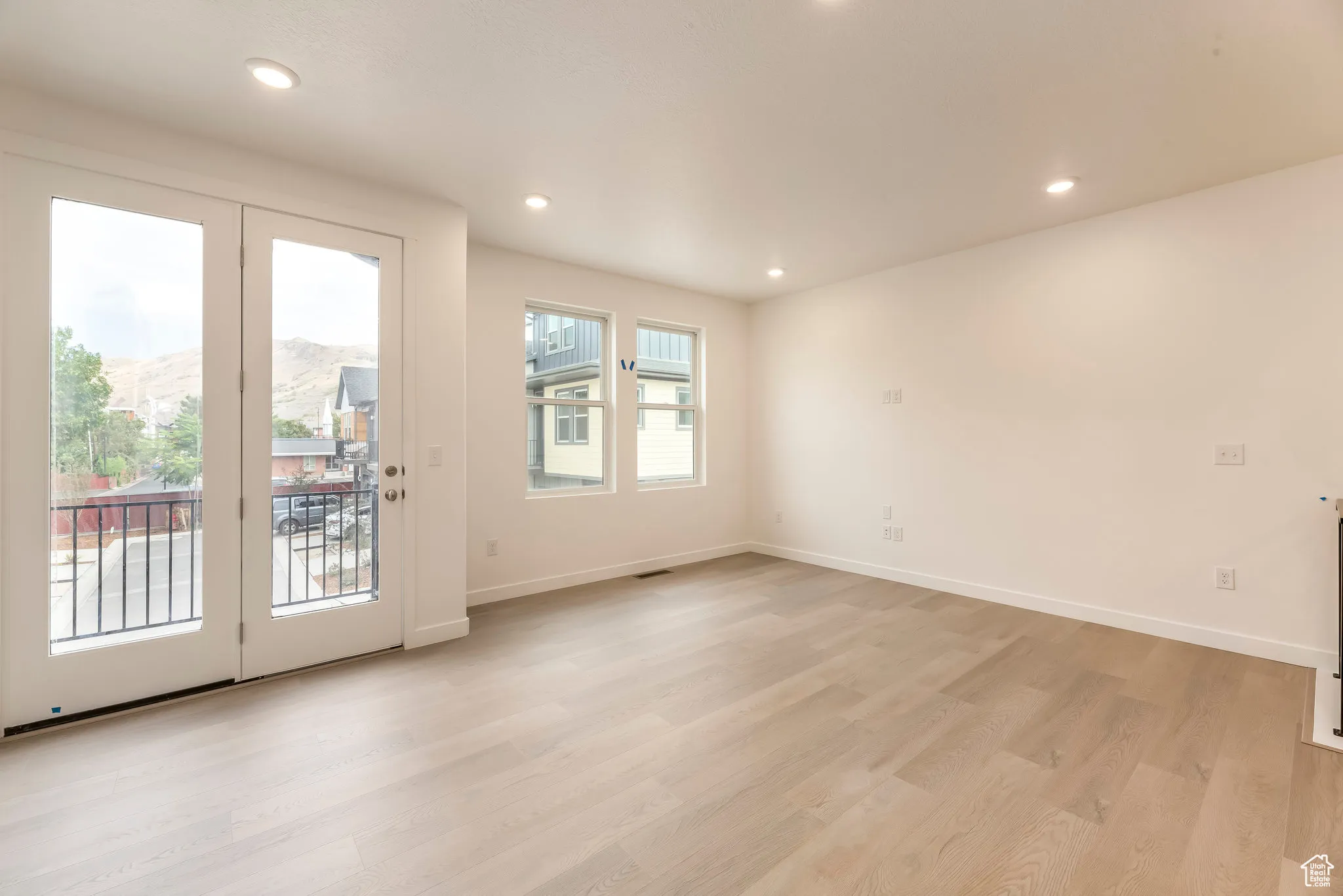 Bright, open living room with large windows and seamless flow—perfect for city living and entertaining.