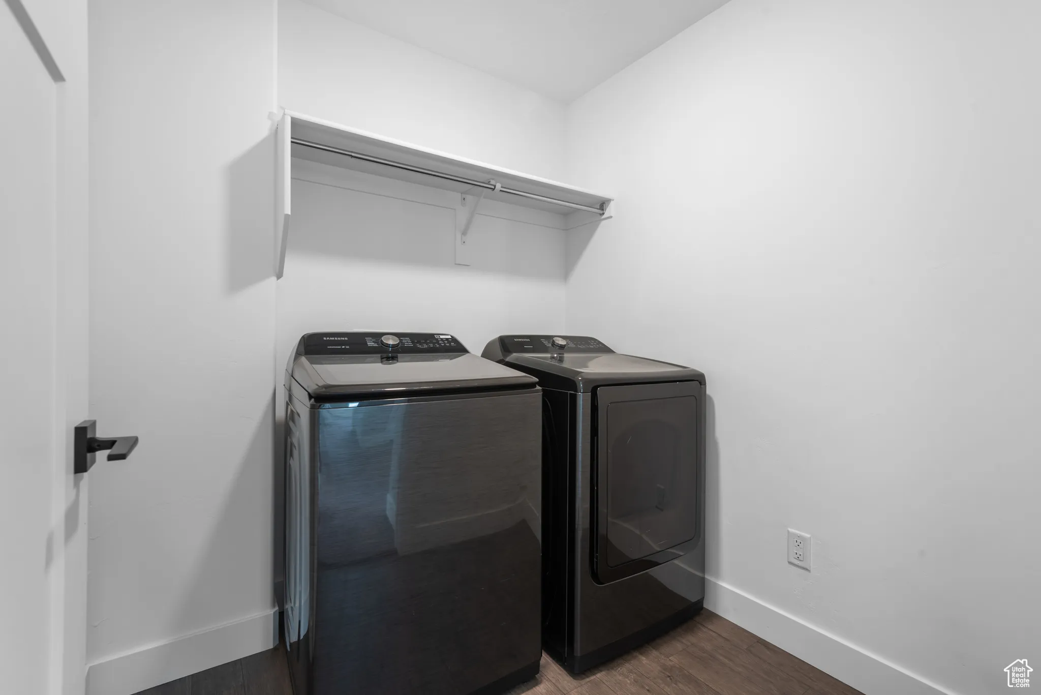 Laundry room featuring independent washer and dryer and dark wood-style floors