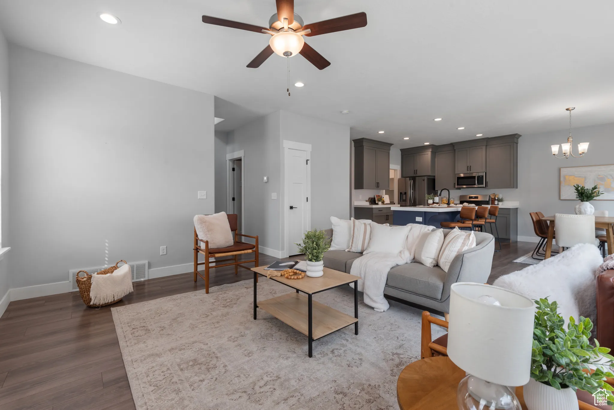 Living area with recessed lighting, dark wood-style floors, a chandelier, and a ceiling fan