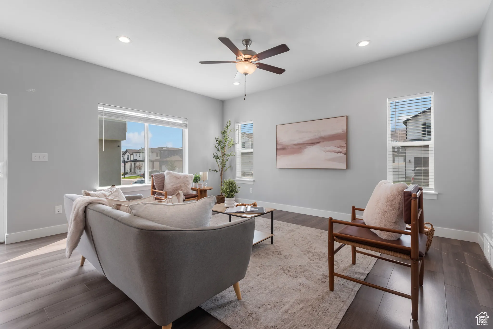 Living room with recessed lighting, healthy amount of natural light, wood finished floors, and a ceiling fan