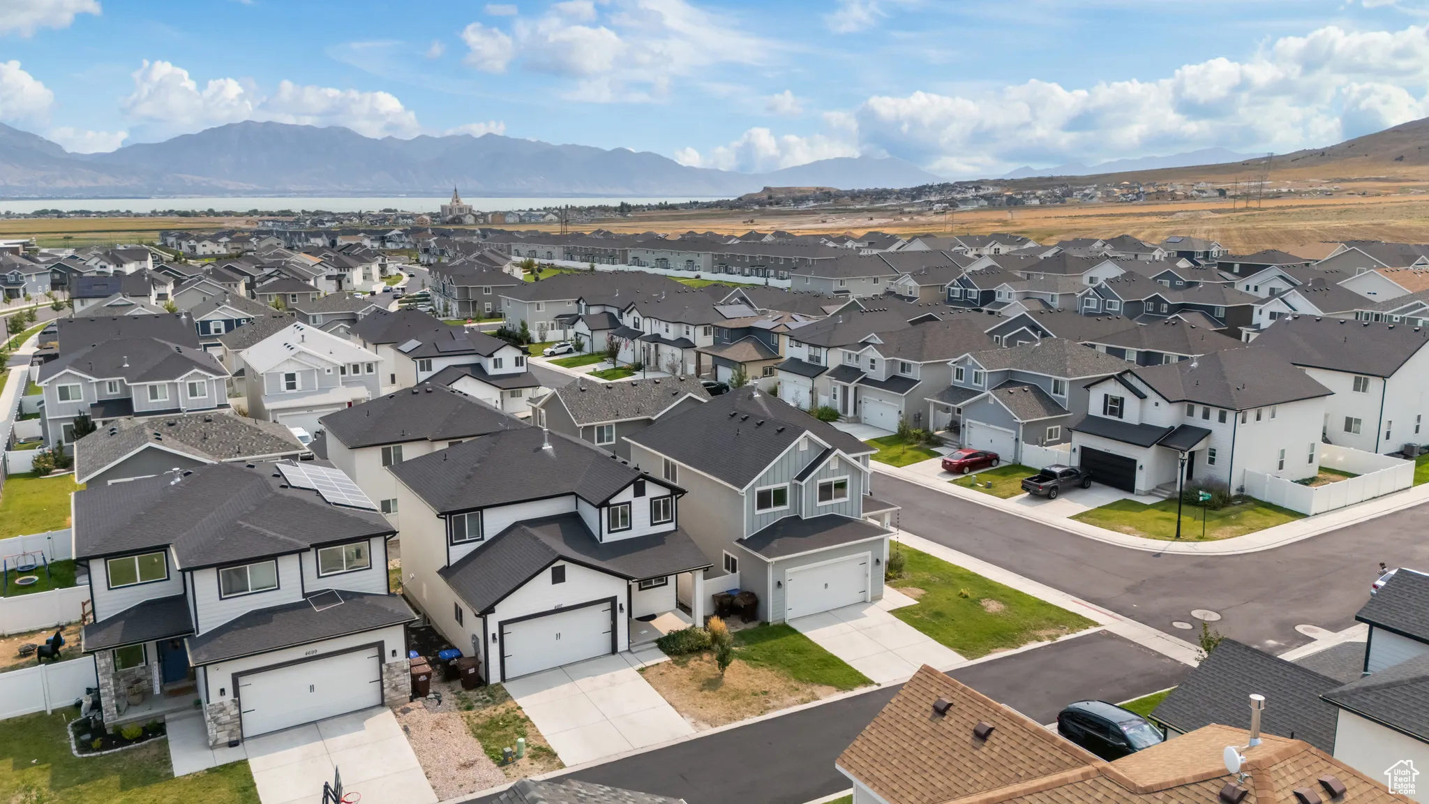 Aerial perspective of suburban area featuring a mountain backdrop