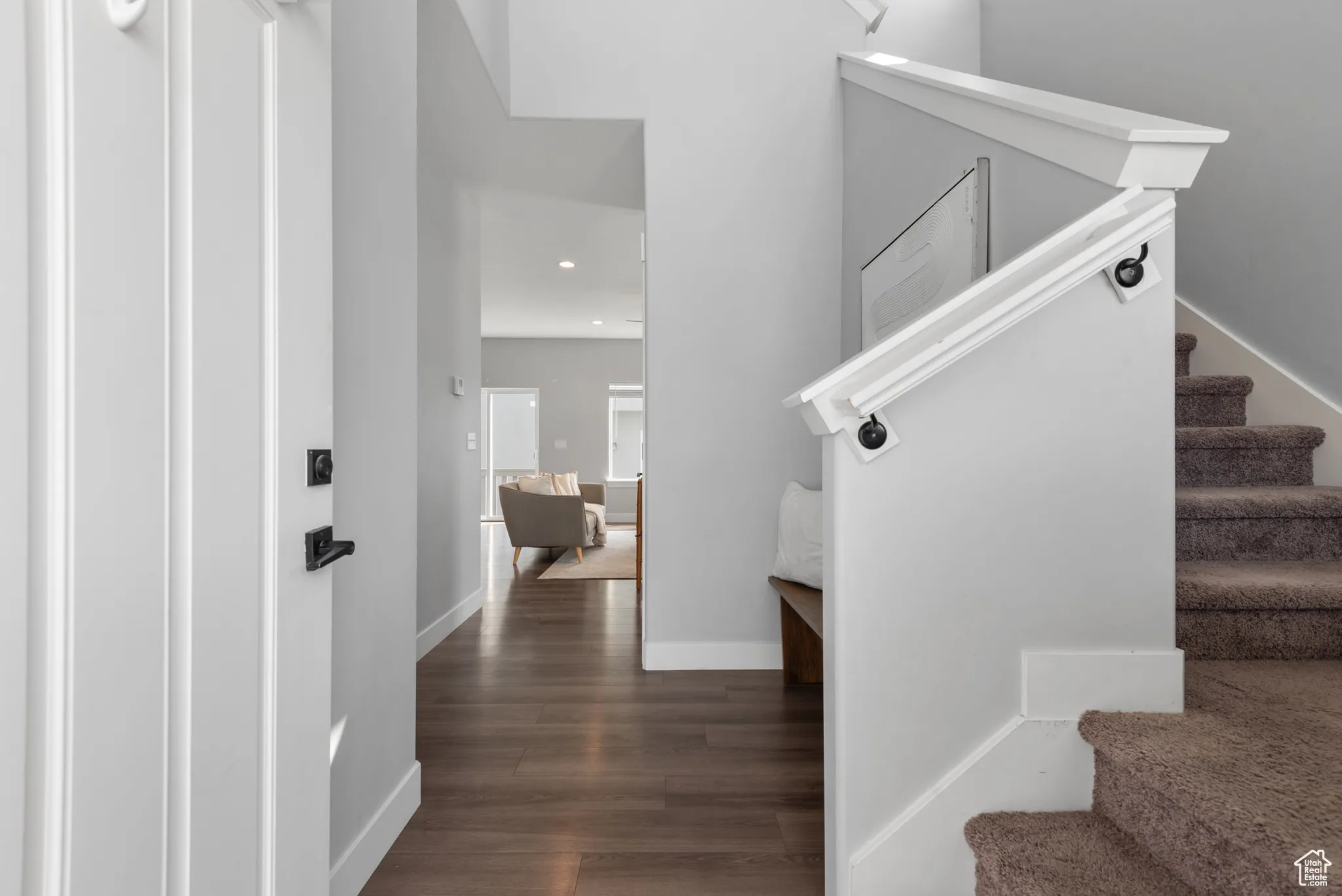 Stairs featuring recessed lighting and wood finished floors