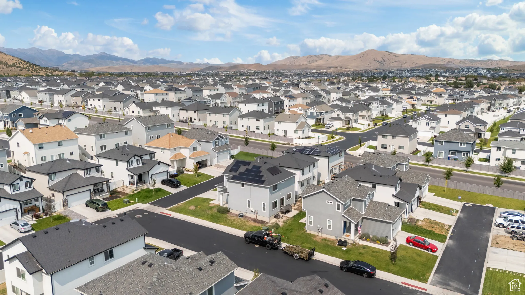 Aerial perspective of suburban area featuring a mountain backdrop