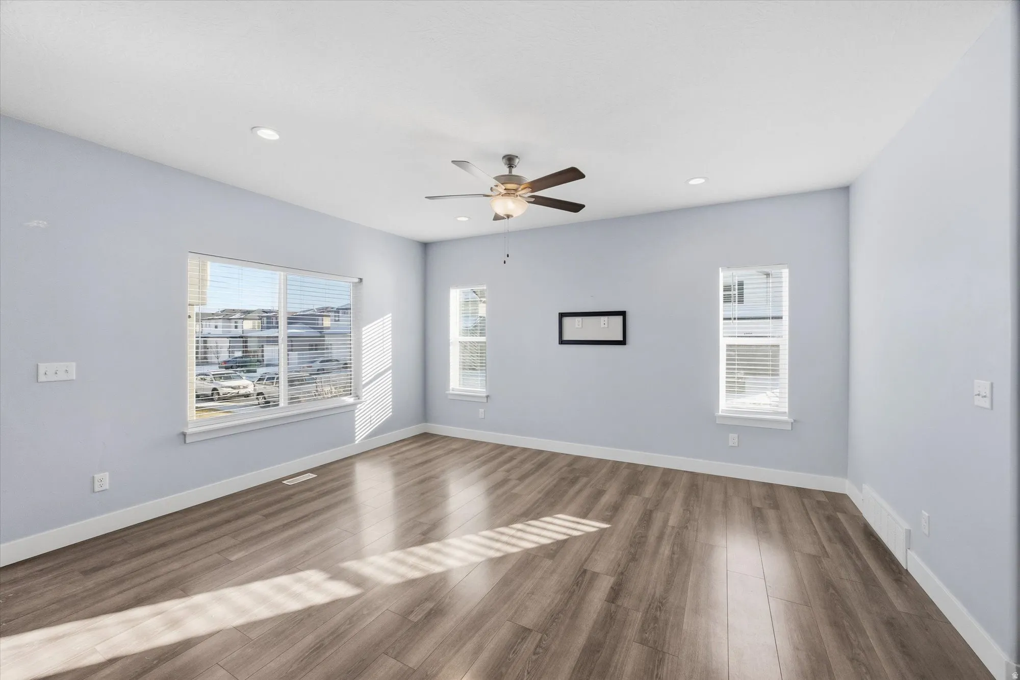 Empty room with wood finished floors, recessed lighting, and ceiling fan
