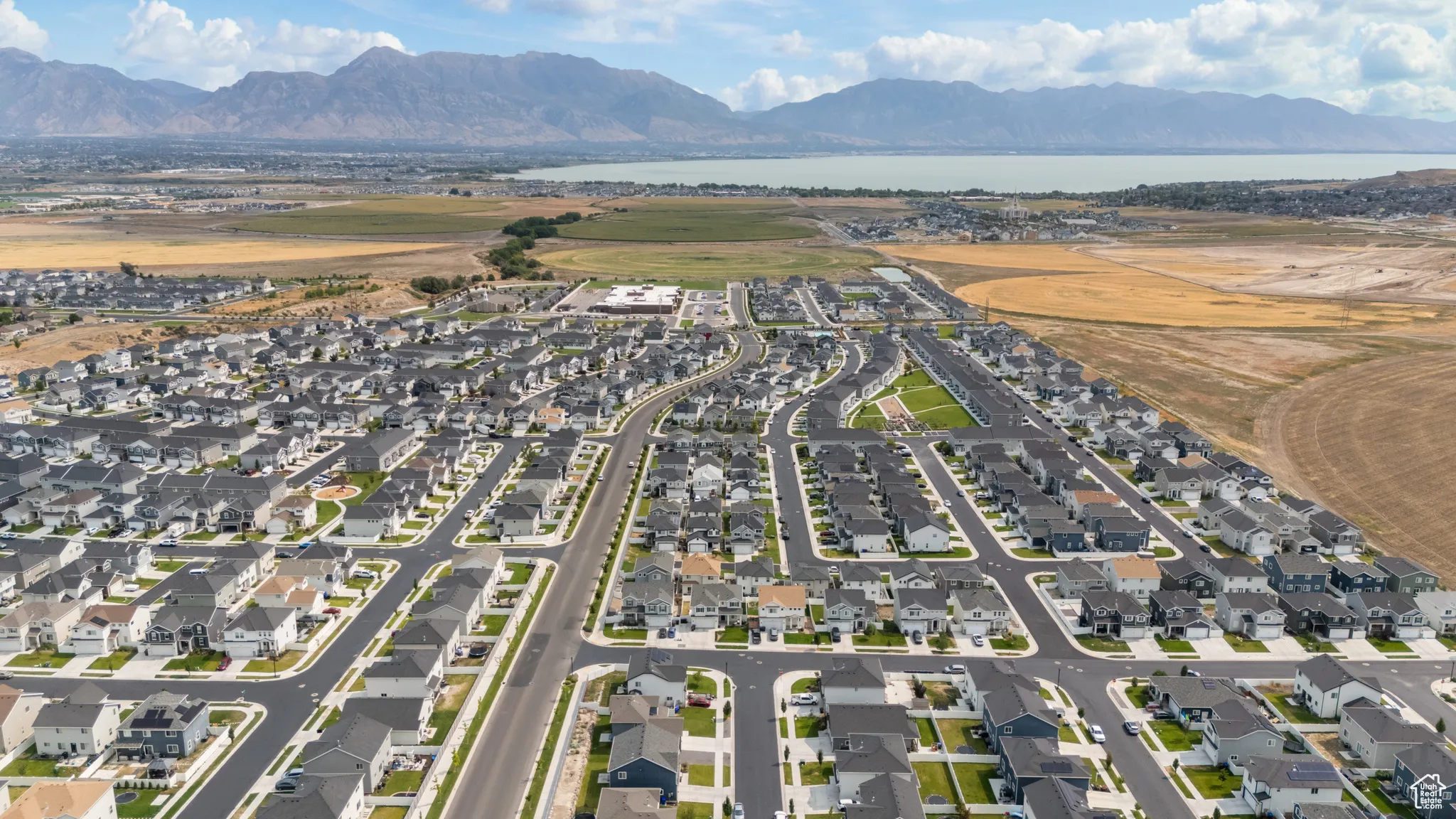 Aerial view of property's location featuring nearby suburban area and a water and mountain view