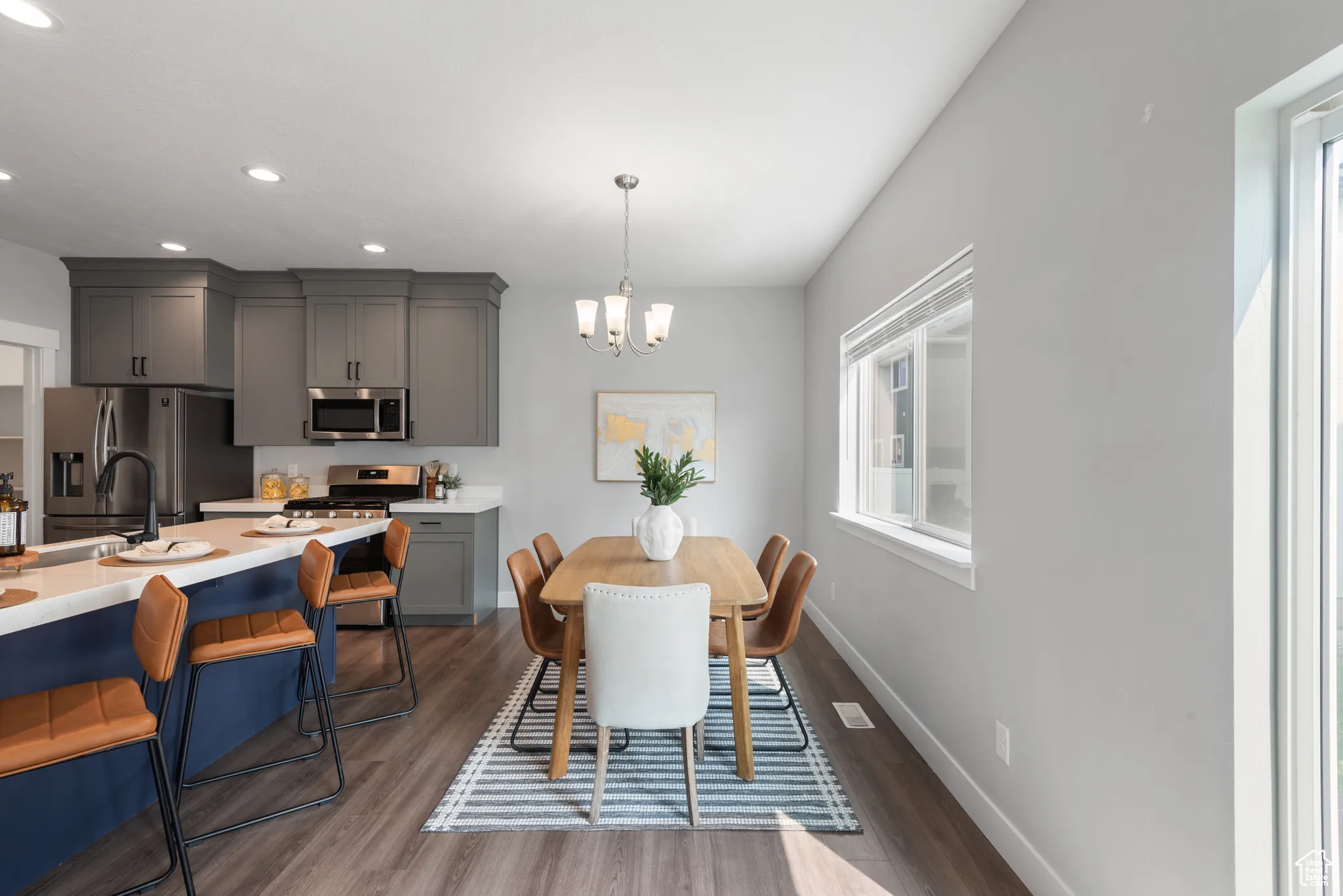 Dining space with dark wood-style floors, a chandelier, and recessed lighting