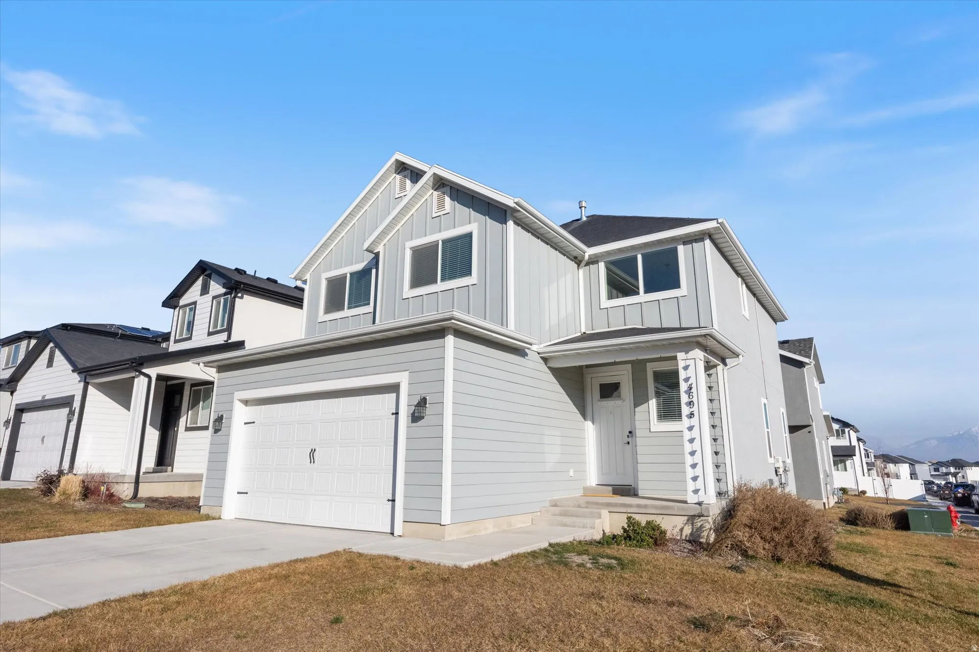 View of front of property featuring concrete driveway, a garage, and board and batten siding