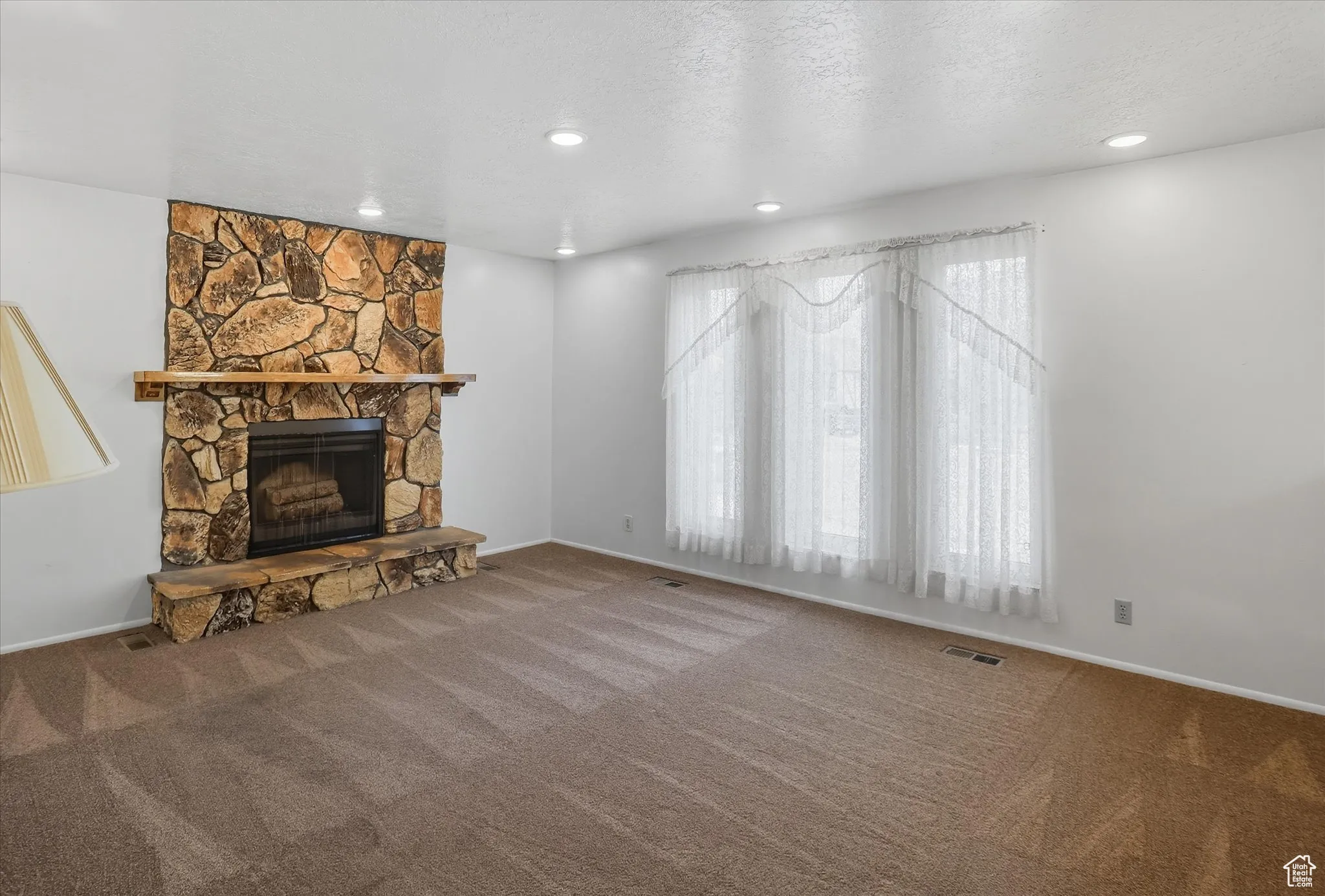 Living room with a fireplace, carpet