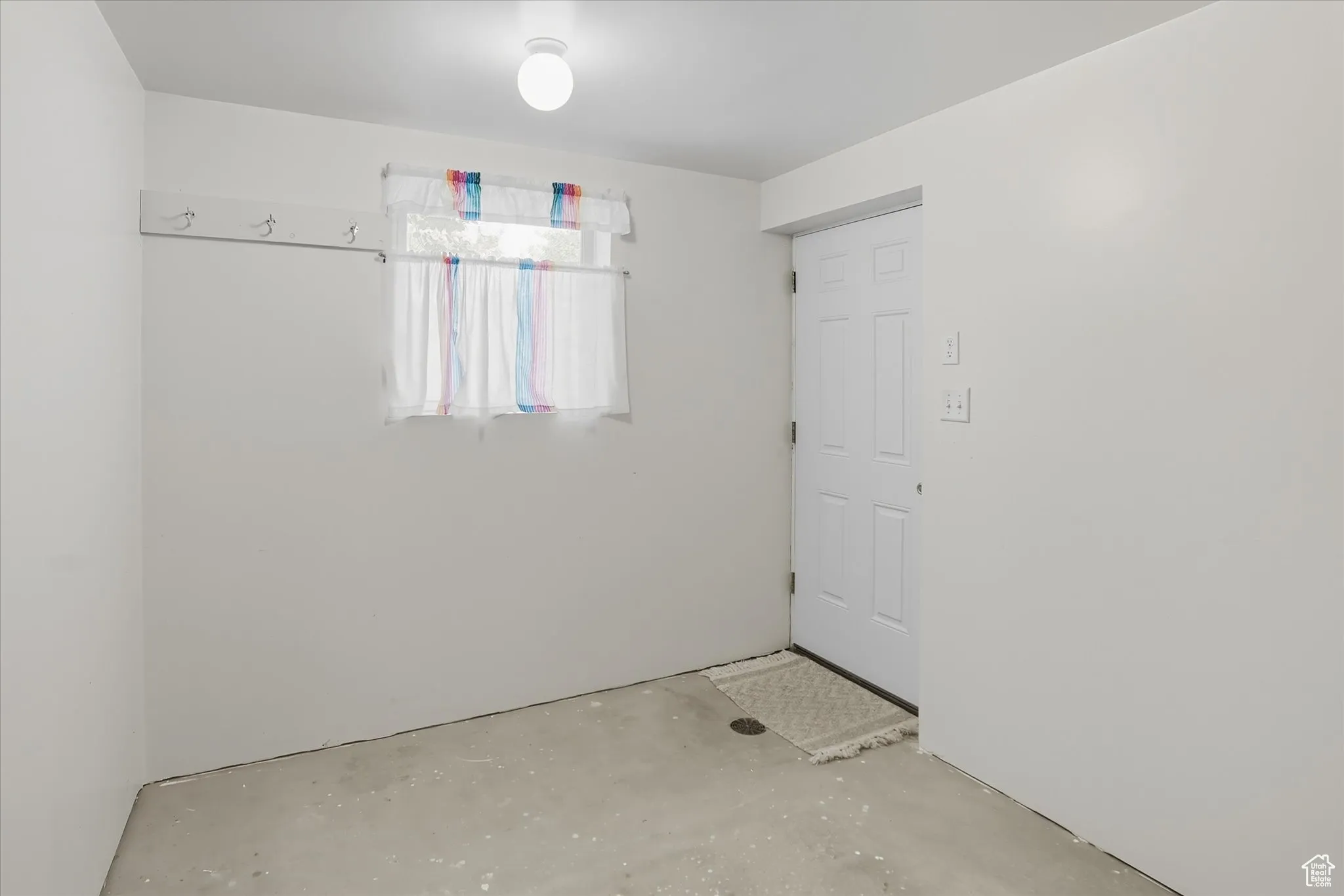Spare room with unfinished concrete floors